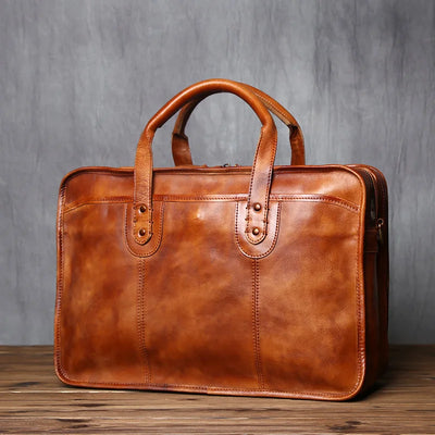 Brown leather briefcase on a wooden surface with a gray background