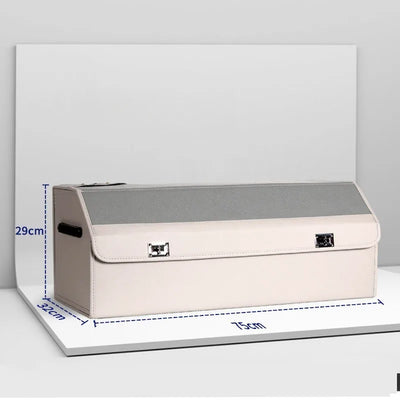 A beige and gray fabric storage box with a hinged lid and metal clasps, shown on a white platform with blue dimension lines indicating 29 cm height, 31 cm width, and 75 cm length.