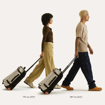 Two people walking with suitcases, one shorter and one taller, on a white background.