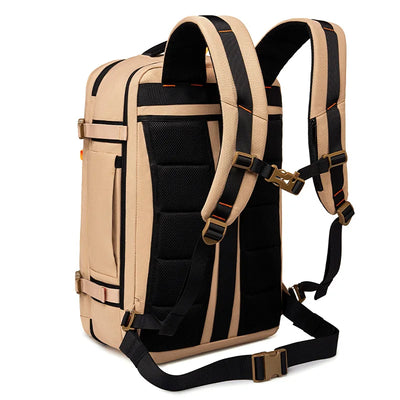 A beige and black backpack shown from the back, featuring padded shoulder straps, a black mesh back panel, and adjustable black straps with brass-tone buckles, set against a plain white background.