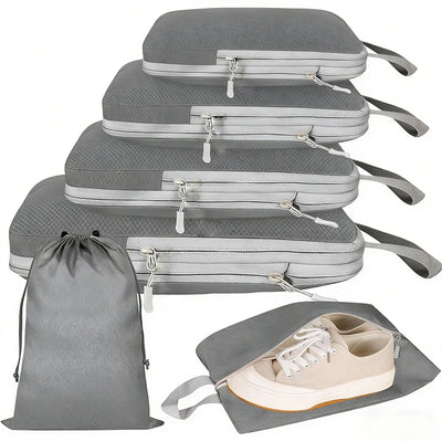 Four gray packing cubes of different sizes stacked vertically, shown with a matching gray drawstring bag and one packing cube holding a pair of beige sneakers, on a white background.